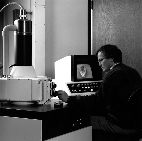 Man using scanning electron microscope