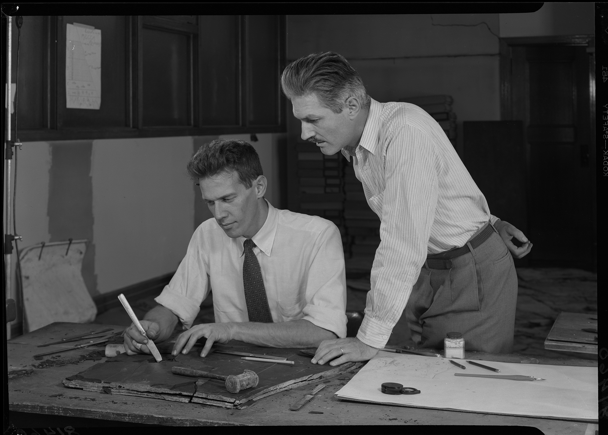 Eugene Richardson and Rainer Zangerl examining fossils in Mecca, Indiana black shale. Room 88, Third or 3rd floor work area.