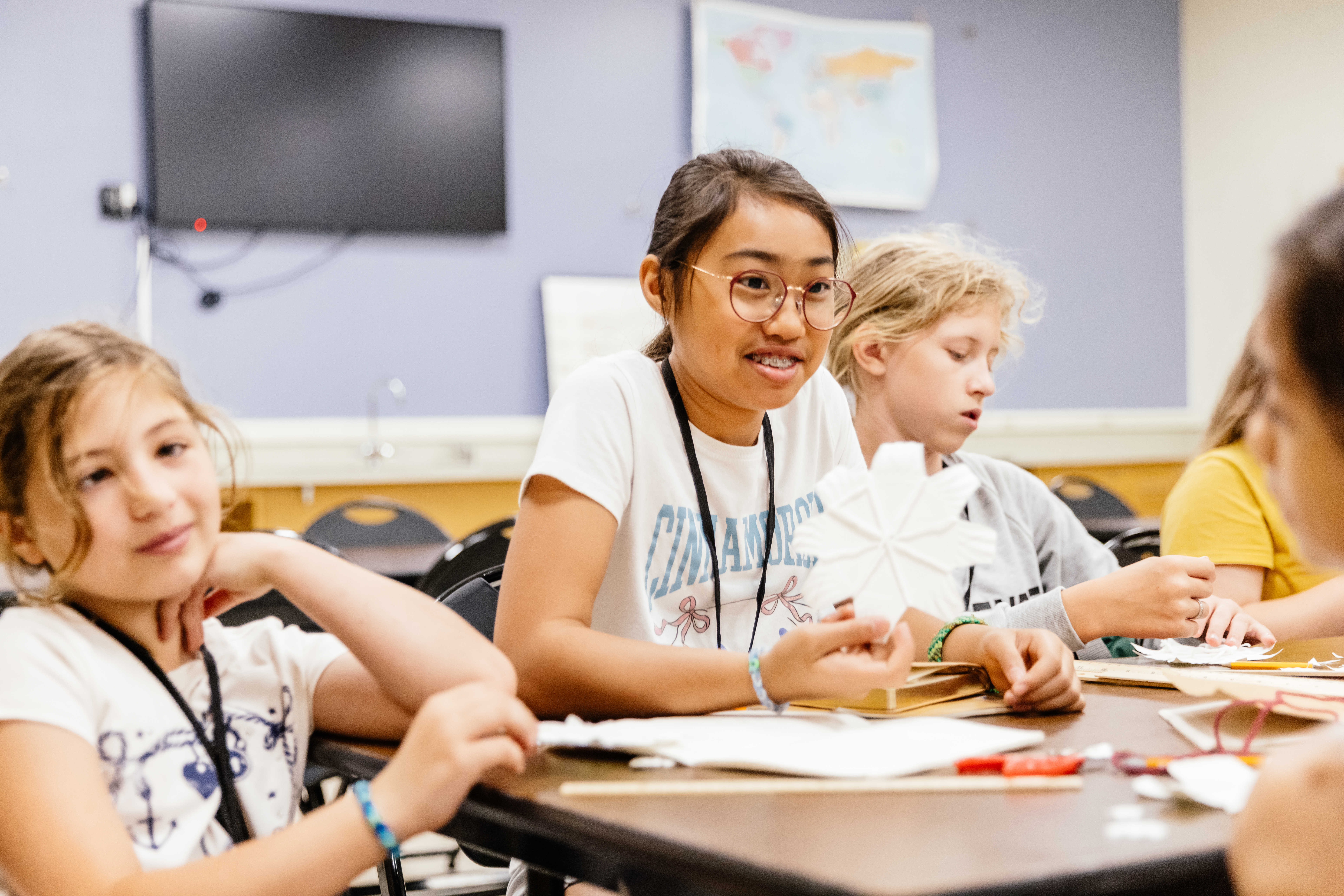 Students seated at a table in a classroom at the museum.