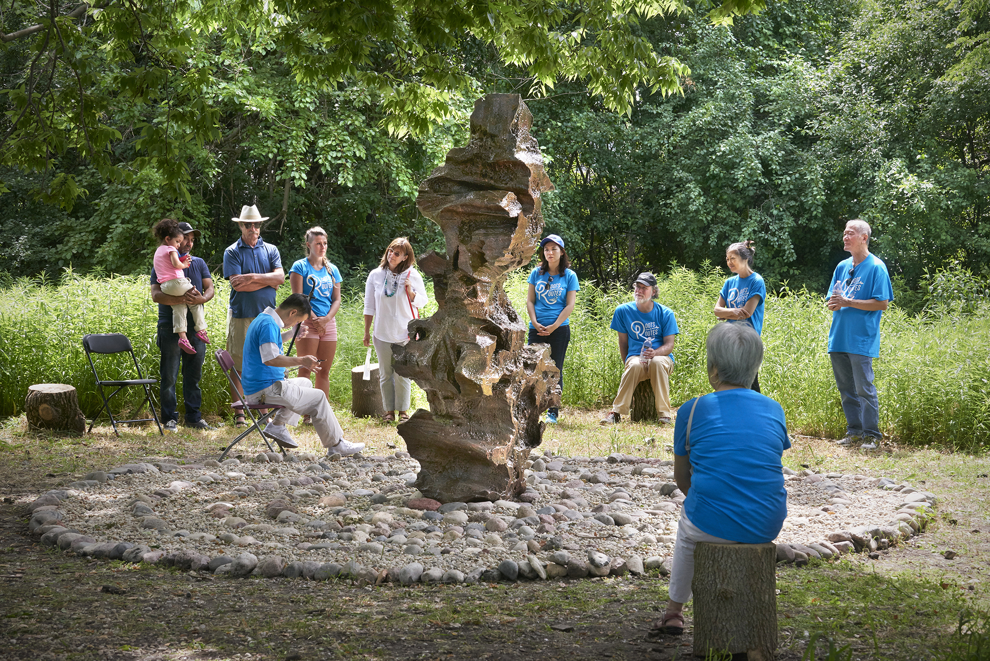 The Set in Stone Gathering Space features an interpretation of a traditional Chinese “scholar’s rock” sculpture in the center of a tranquil rock garden with hand-carved log benches for viewing and contemplation.