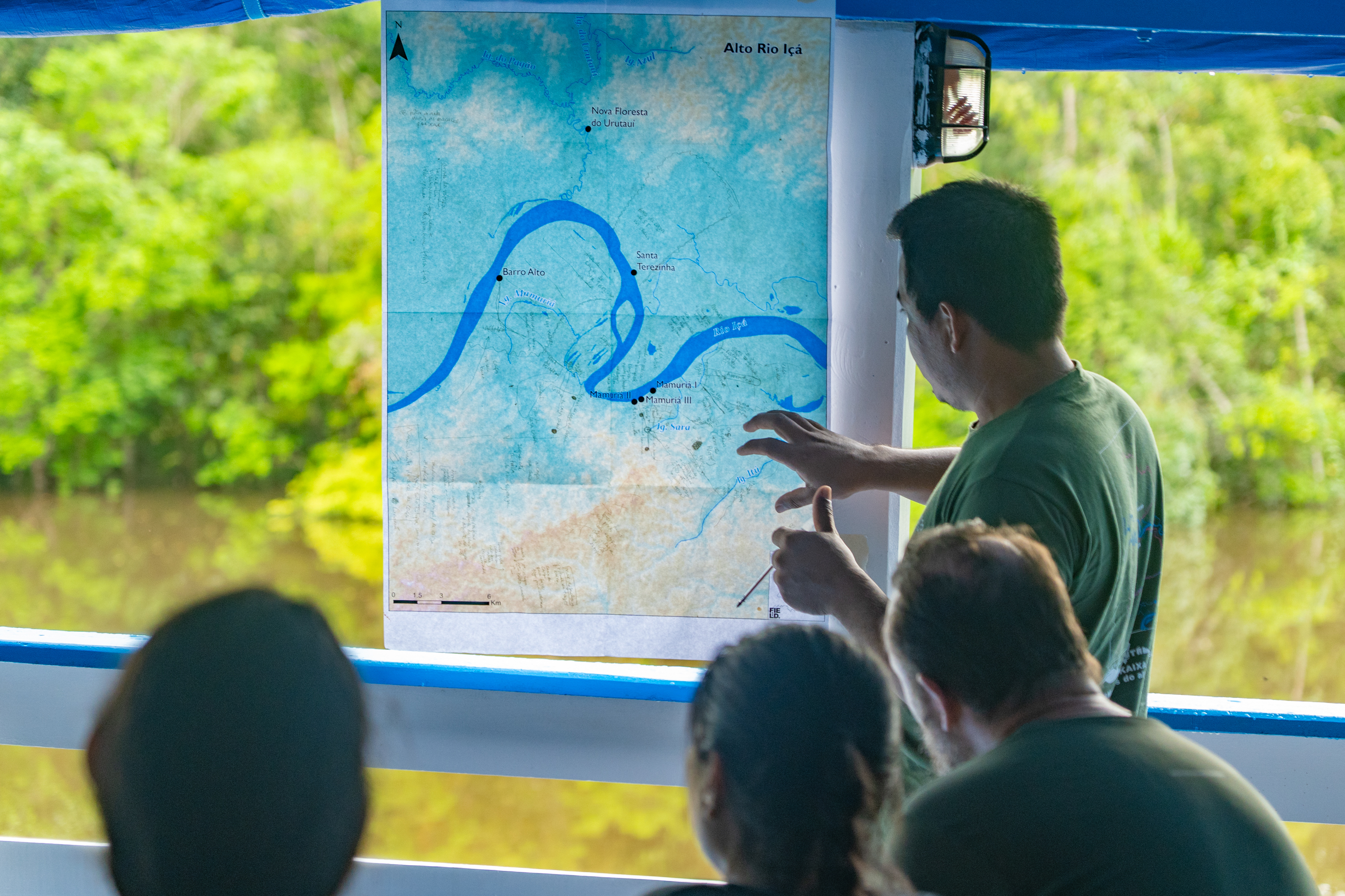 Social scientist Elivanderson Chota looking at map
