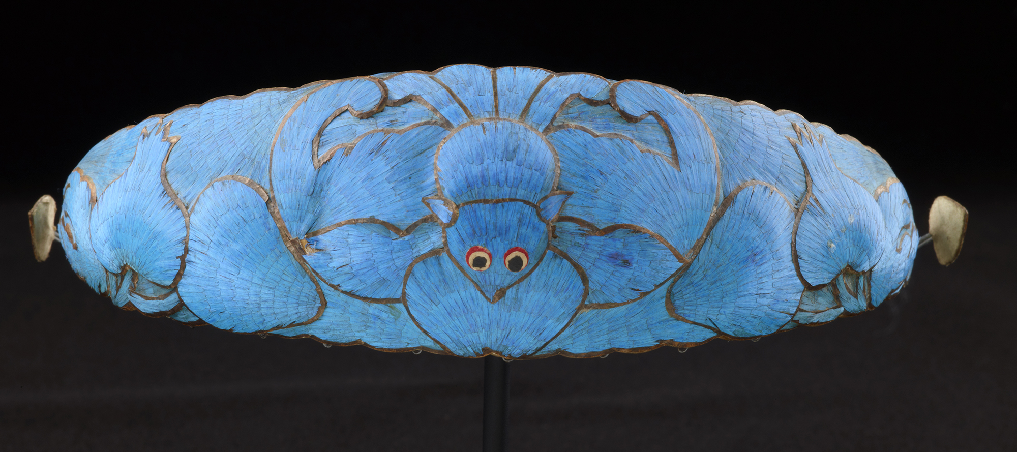 A headband made from delicately arranged brilliant blue Kingfisher bird feathers.