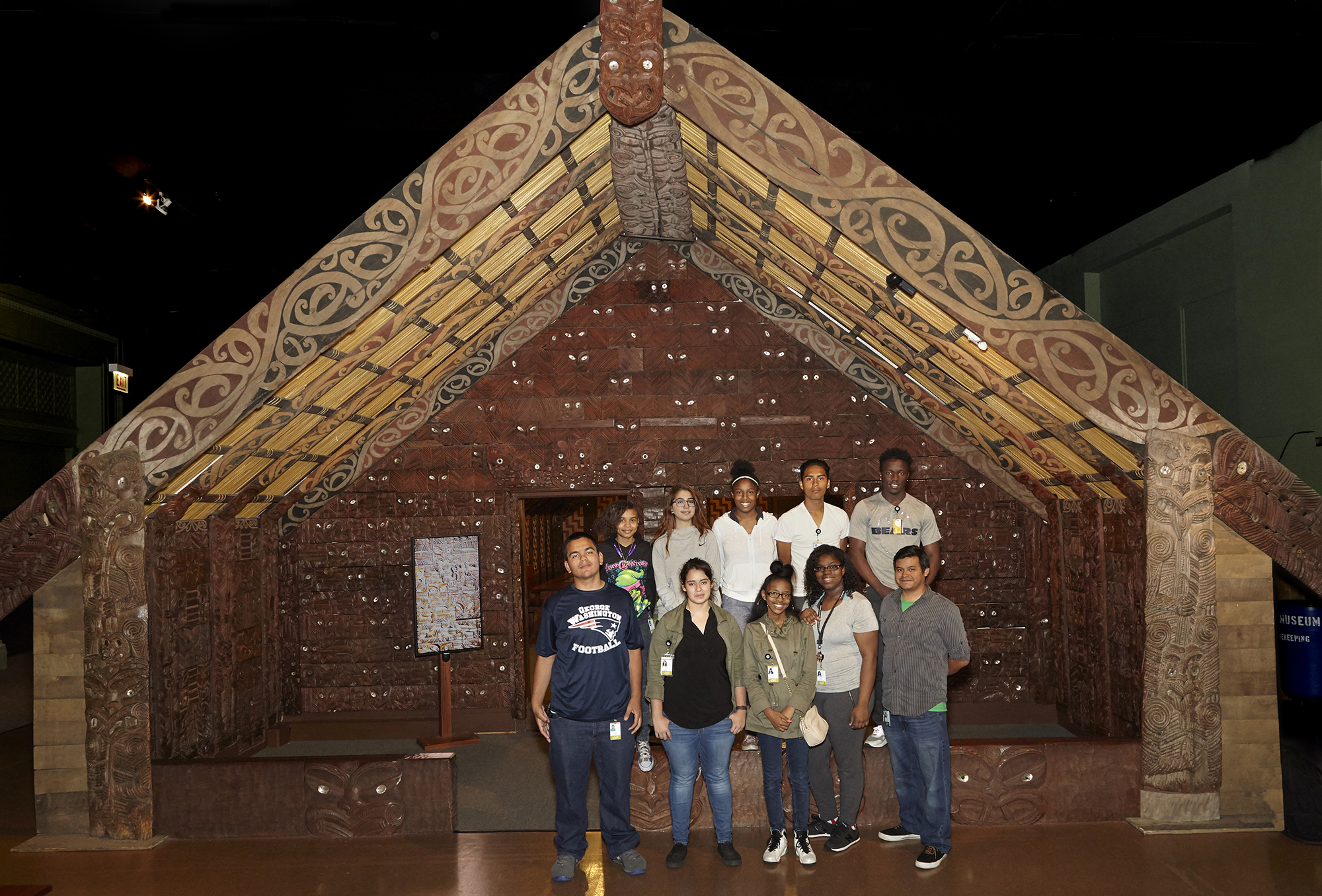 Group of interns stand outside of the Maori meeting house