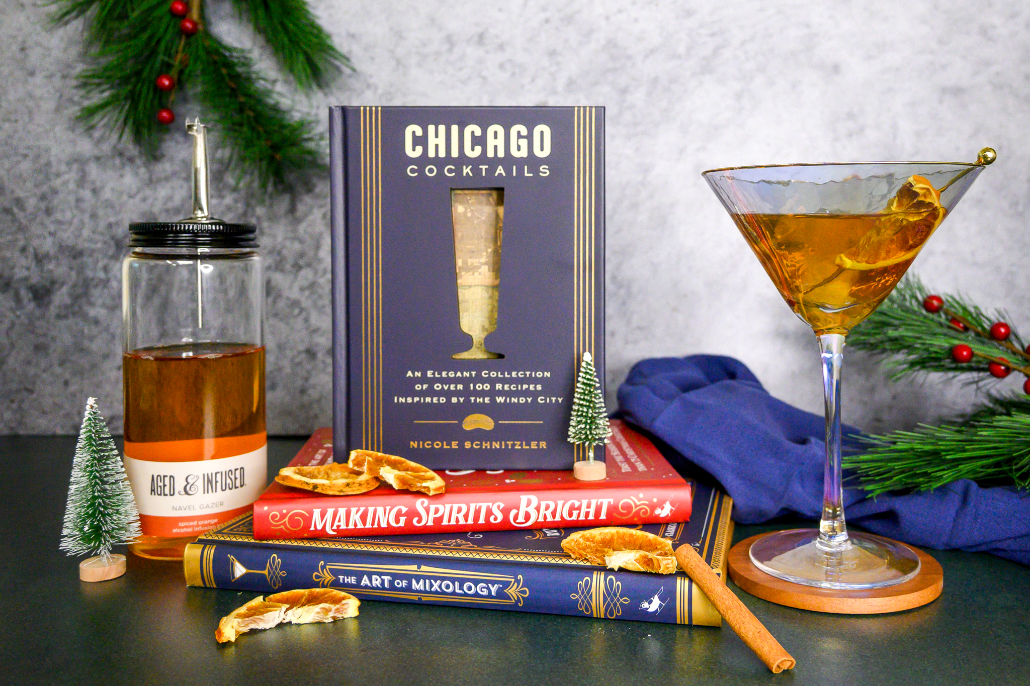 Items from the Field store including an Aged & Infused alcohol infusion kit and three books: Chicago Cocktails, Making Spirits Brights, and The Art of Mixology