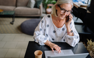 A person on the phone and laptop