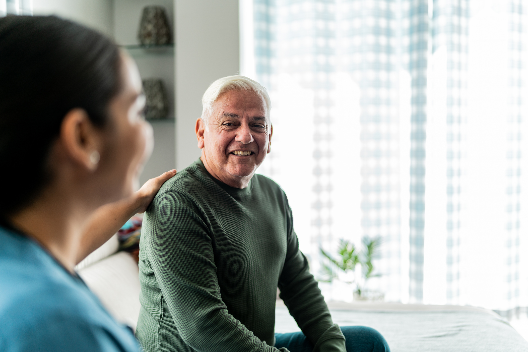 Doctor talking with elderly man patient