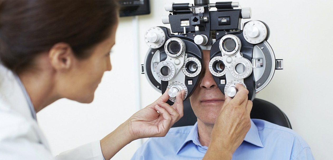 Medical personal performing an eye test on a patient.