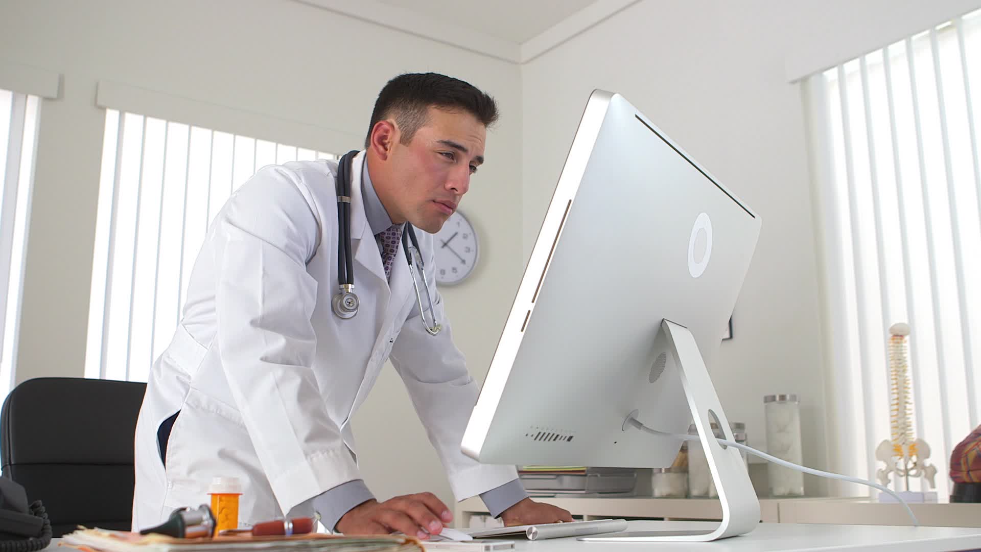 GP in front of his computer.