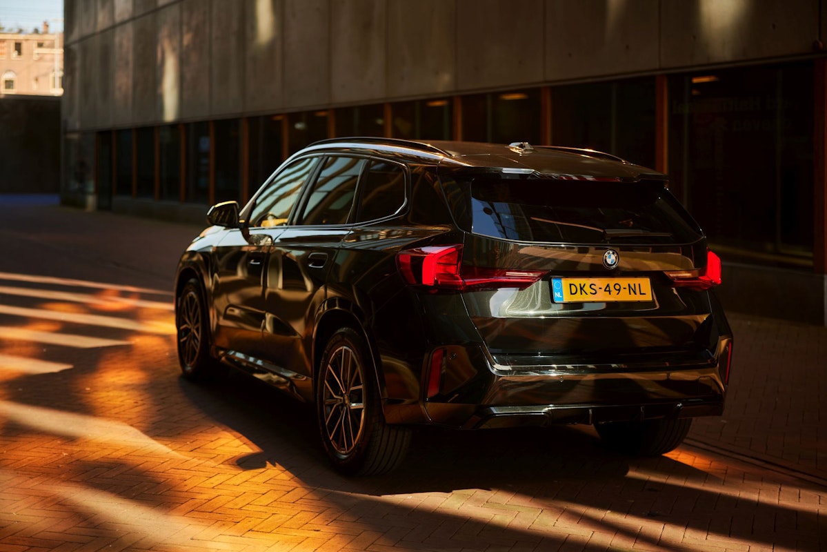BMW SUV short-lease at DIKS in Amsterdam, parked in front of an office building.