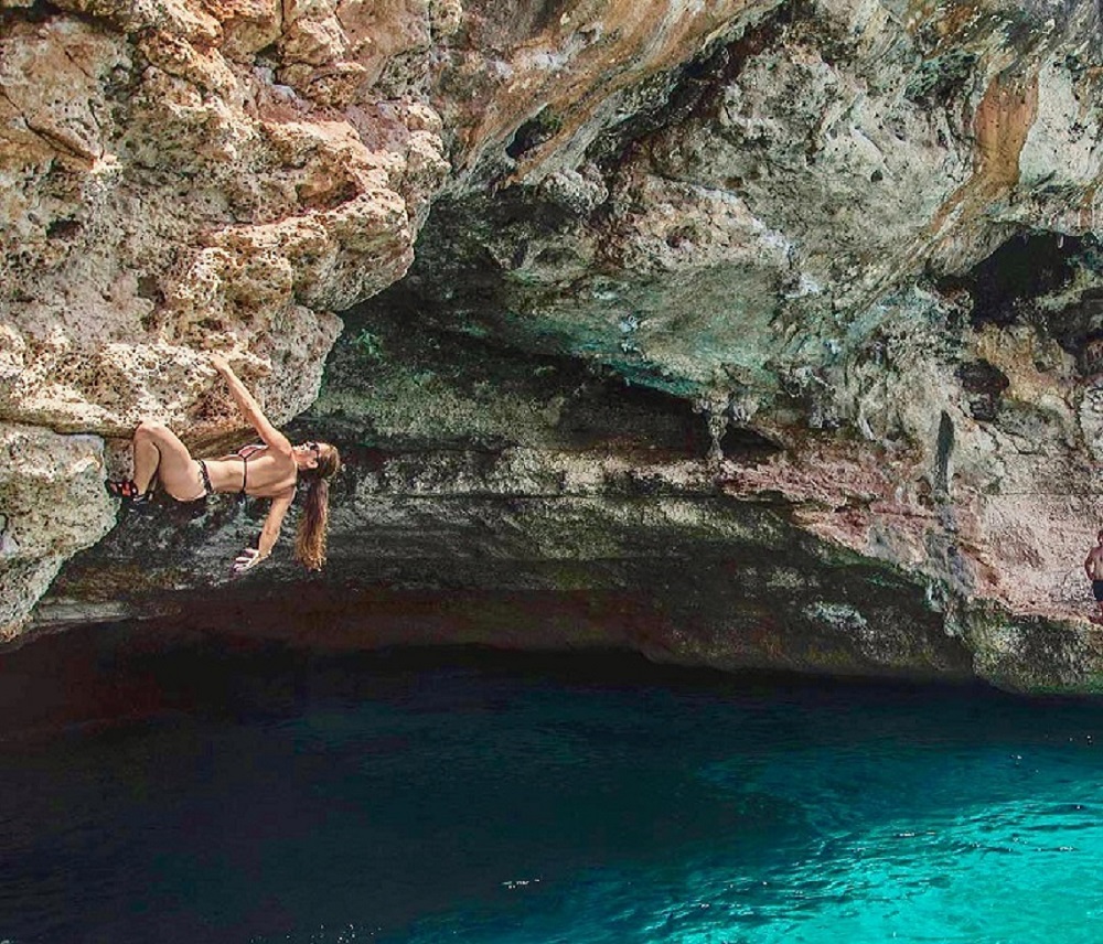 Lena Drapella Climbs over the cave entrance at Cala Varques. This is also a fantastic cliff jumping spot.  Jase Wilson