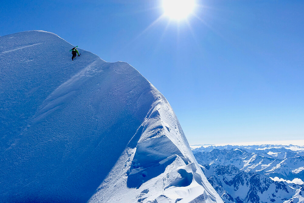 Enrico down climbing near Middle Peak of Aoraki/Cook towards the start of the line. Photo: Tom Grant