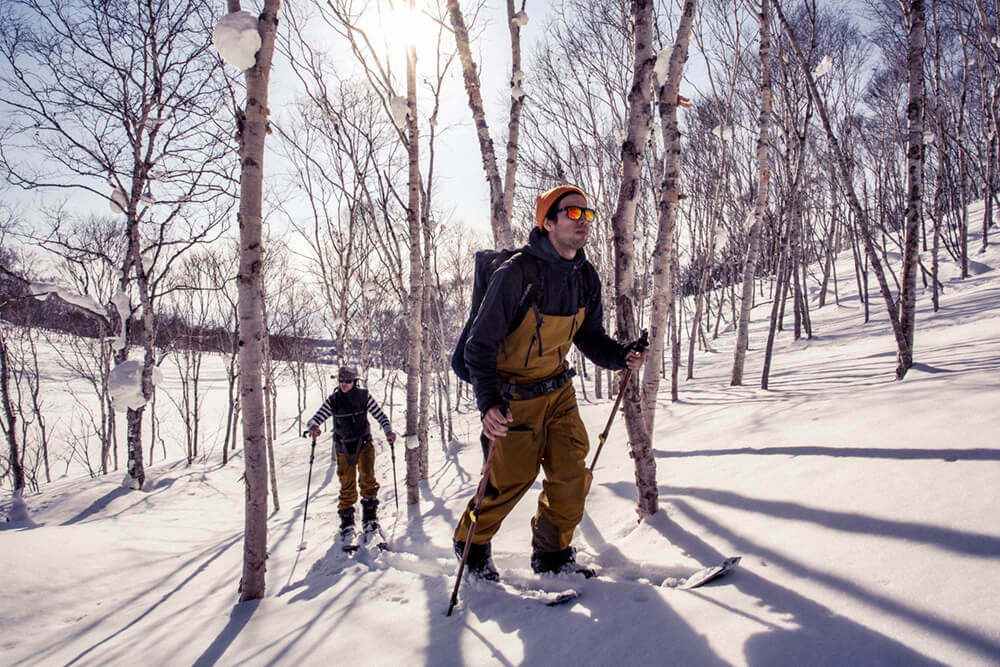 It was all about earning our turns as we hiked through the woods searching for spots! Photo: Simon Rainer