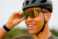 cyclist in helmet wearing SunGod gold lens sunglasses