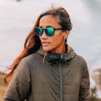 woman wearing SunGod green lens sunglasses in an outdoor environment