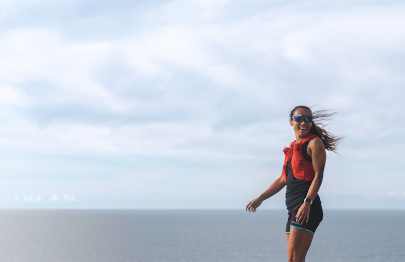 Female trail runner wearing SunGod sunglasses