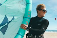 man wearing kitesurfing sunglasses at the beach