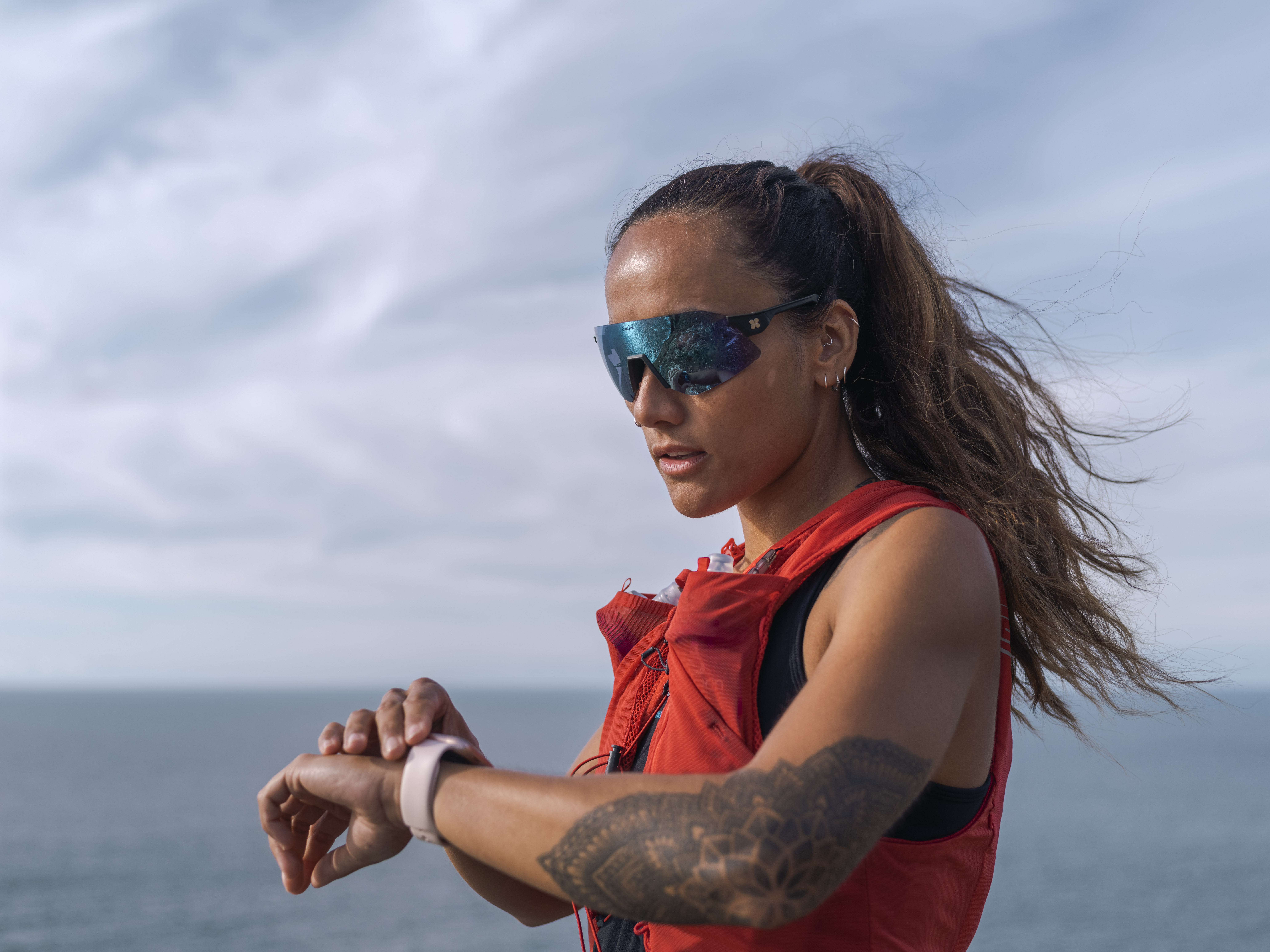 woman looking at watch whilst running