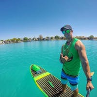 man wearing green lens paddle board sunglasses