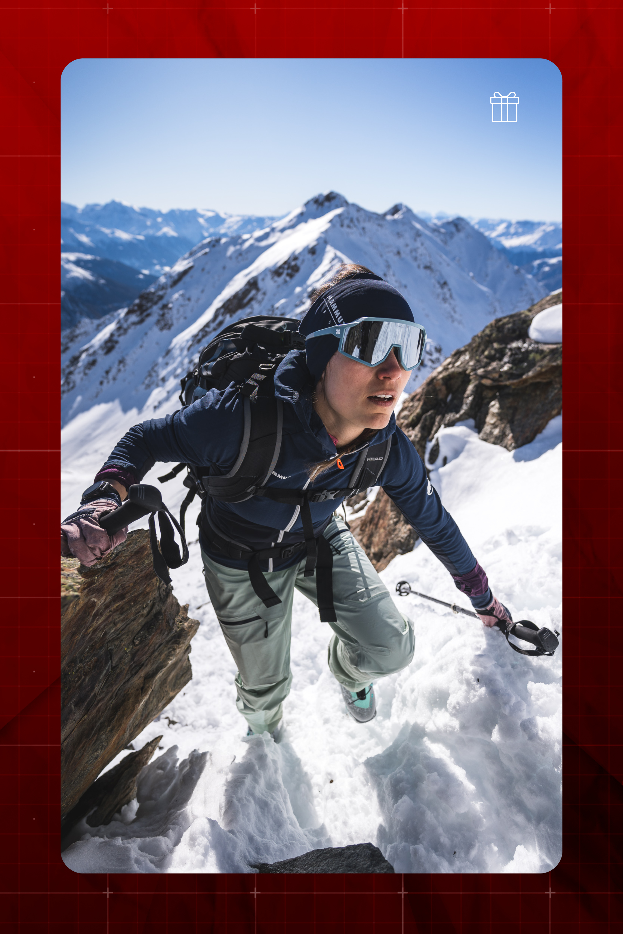Woman in sunglasses climbing a snowy mountain