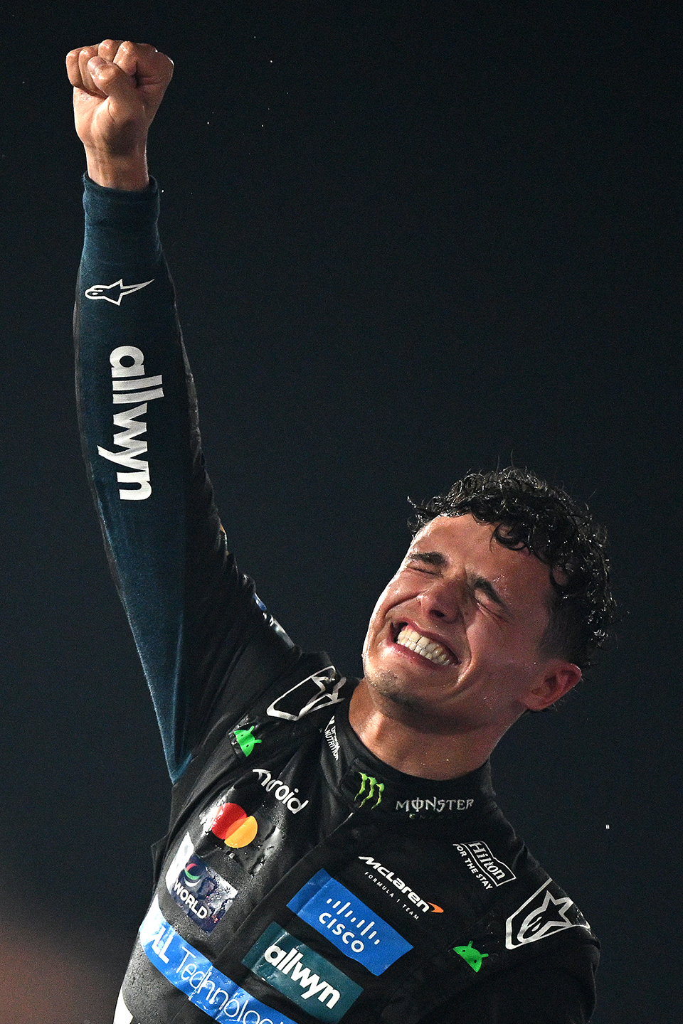 lando norris with fist in the air in triumph