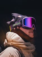 man wearing purple snowboard goggles