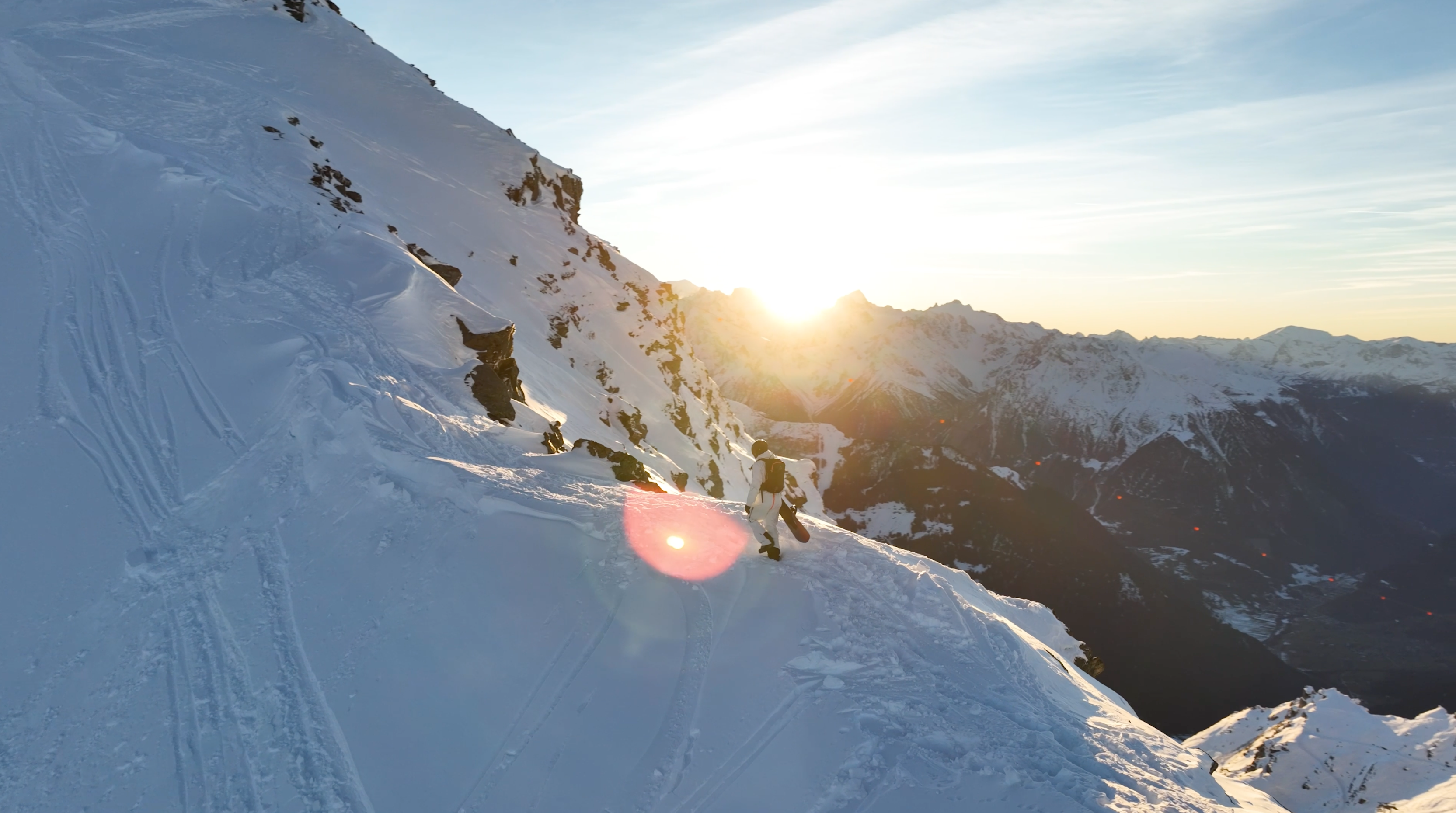 sun rising over snowy mountains