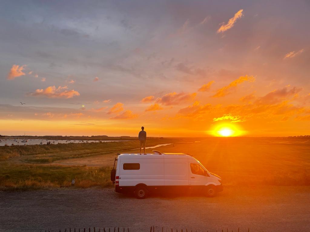 van in front of a sunrise