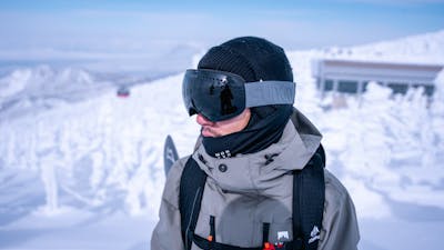 Man in front of snow in SunGod goggles