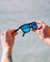 Blue lens sunglasses in hands