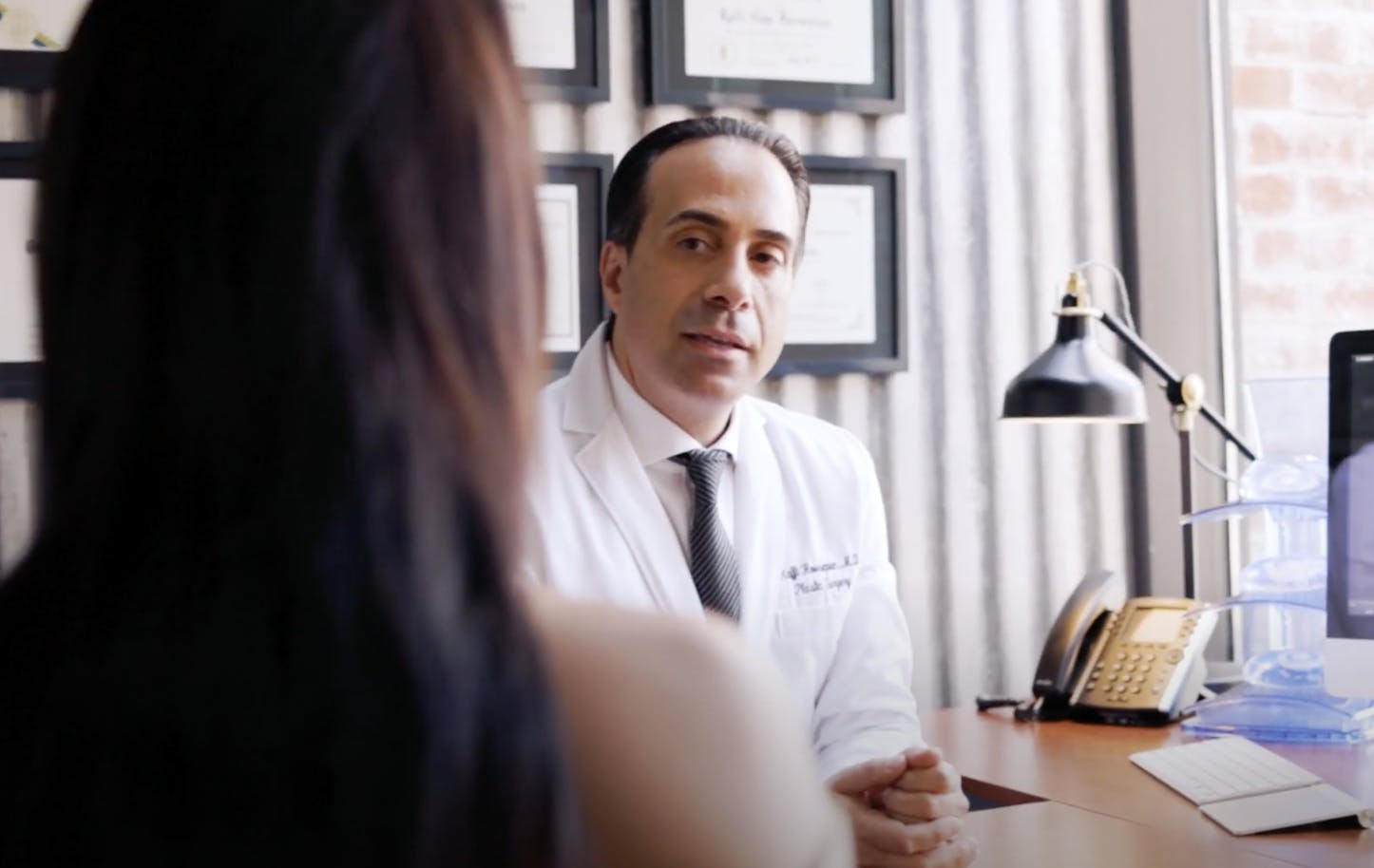 Dr. Hovsepian talking to a patient in his office