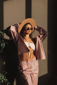 model in hat and white tube top