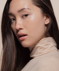 Woman looking over her shoulder with her mouth slightly open