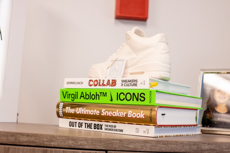 a stack of books and a nike shoe in Dr. Bloom's office