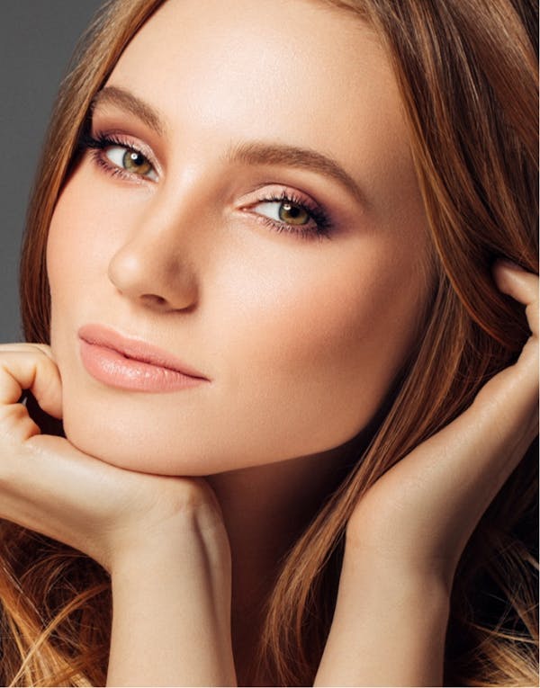 Woman resting her face on her hand