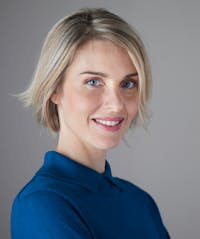 Woman with short blonde hair smiling
