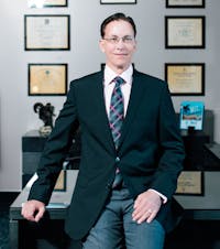 Dr. Sofonio wearing suit in office