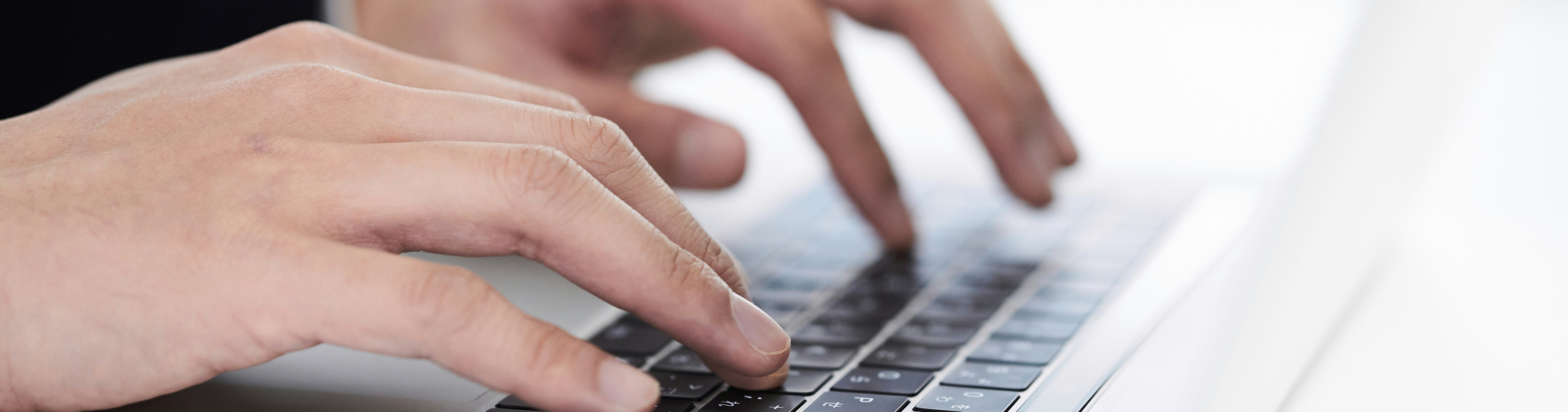 business man typing management summary on laptop