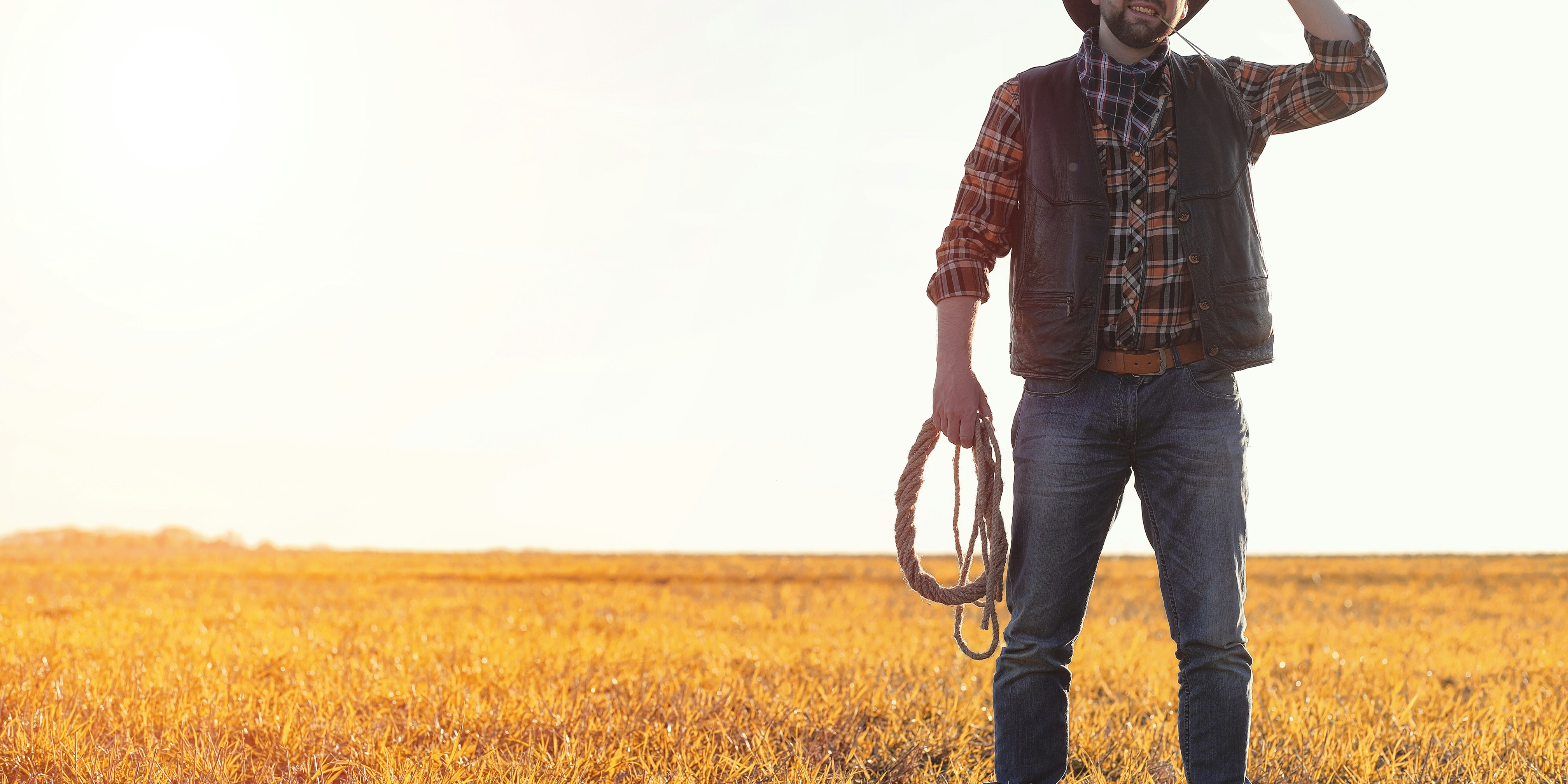 How to install Rancher RKE2 on CentOS Stream 8 blog post hero image, cow boy standing in field with lasso
