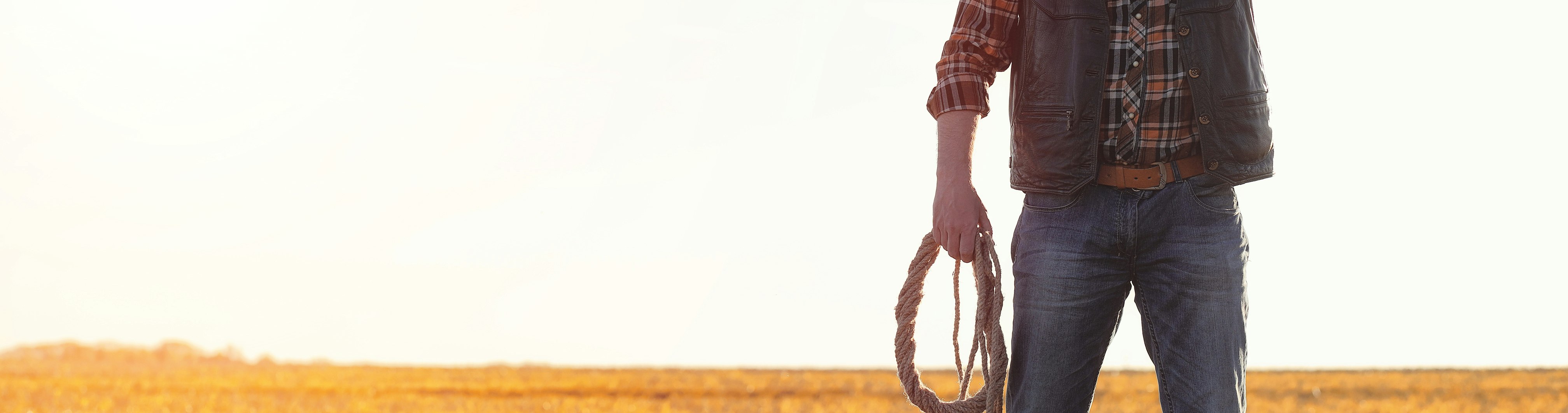 How to install Rancher RKE2 on CentOS Stream 8 blog post hero image, cow boy standing in field with lasso