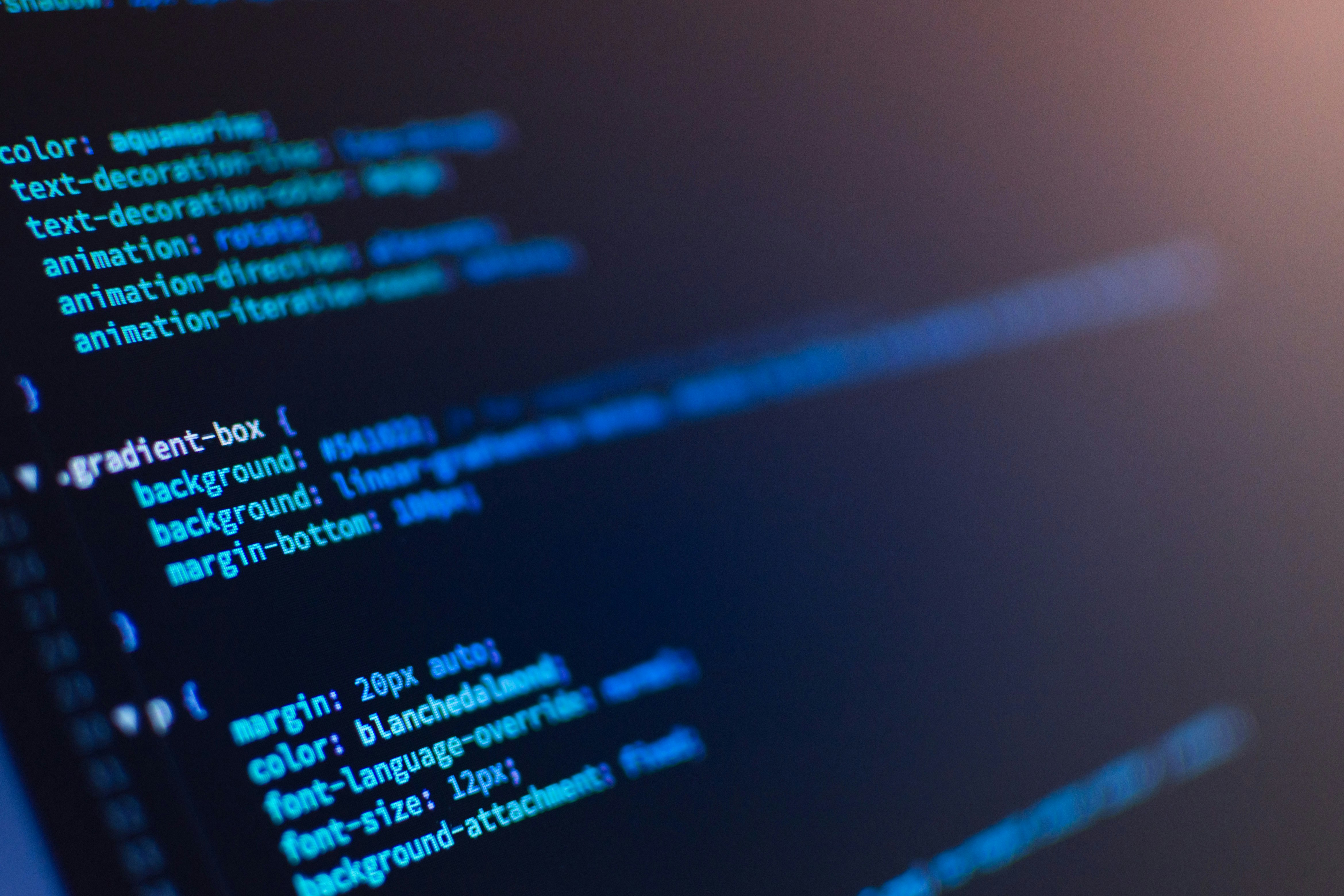 JAMstack vs WordPress for building websites blog post hero image, css code on computer screen