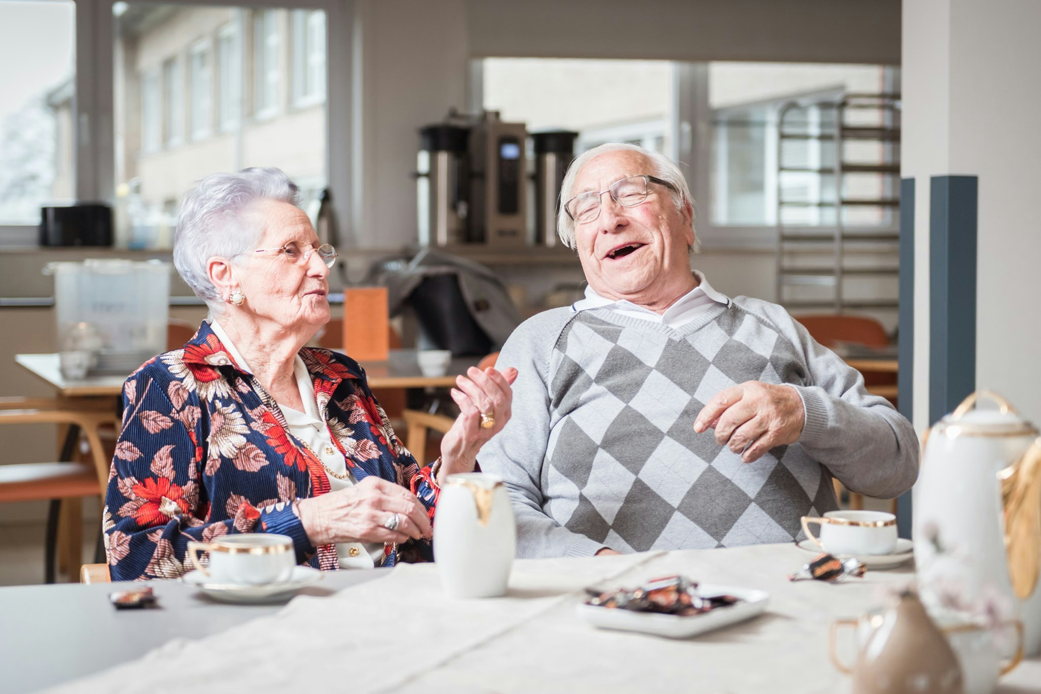 Motena hero image, two elderly people enjoying care in nursery home