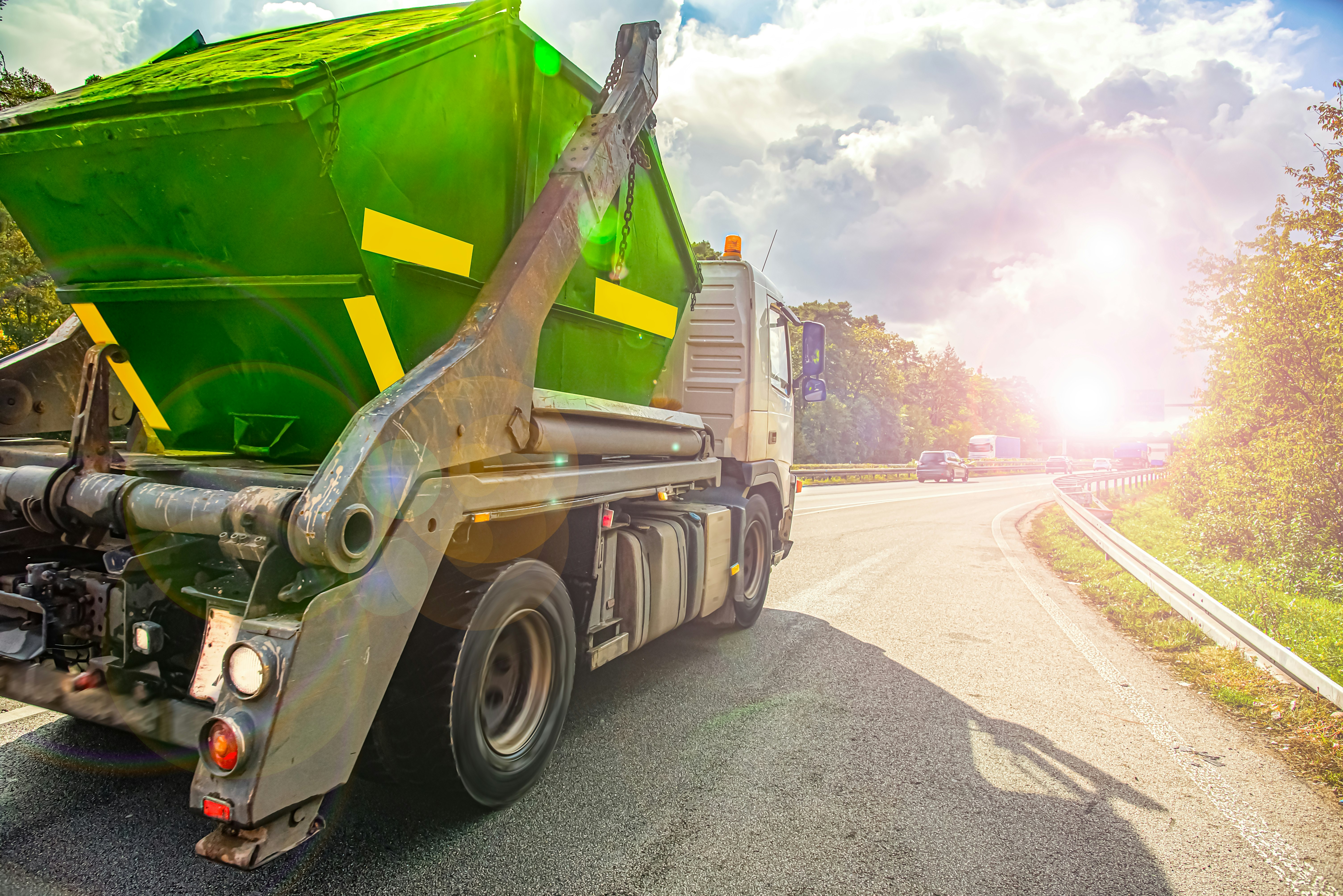 Garbage truck driving on the road