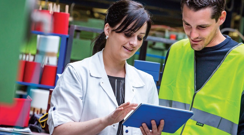 Safety inspectors in the workplace looking at tablet
