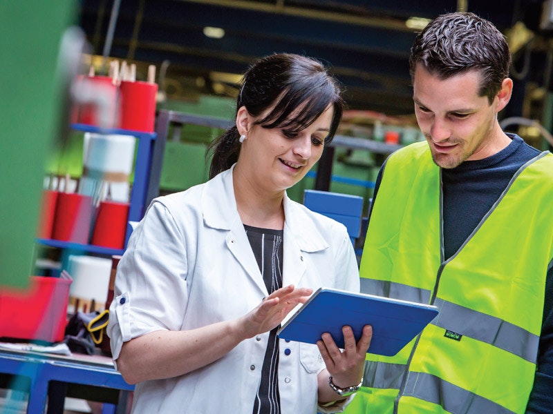 Safety inspectors in the workplace looking at tablet