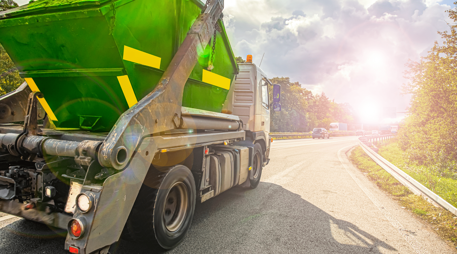 Garbage truck driving on the road