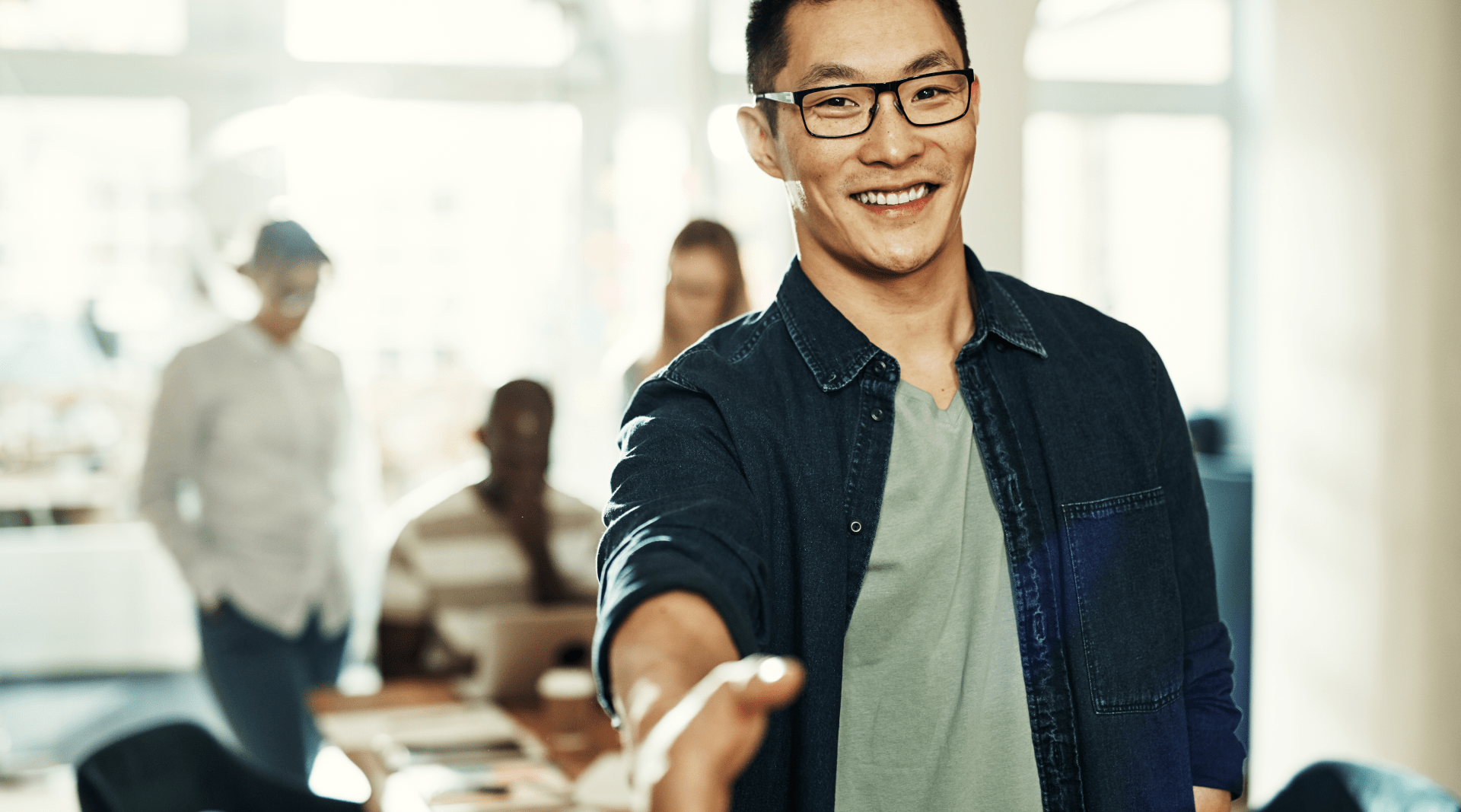 Designing for optimal user-client-developer relationships  hero image, man extending hand for a handshake