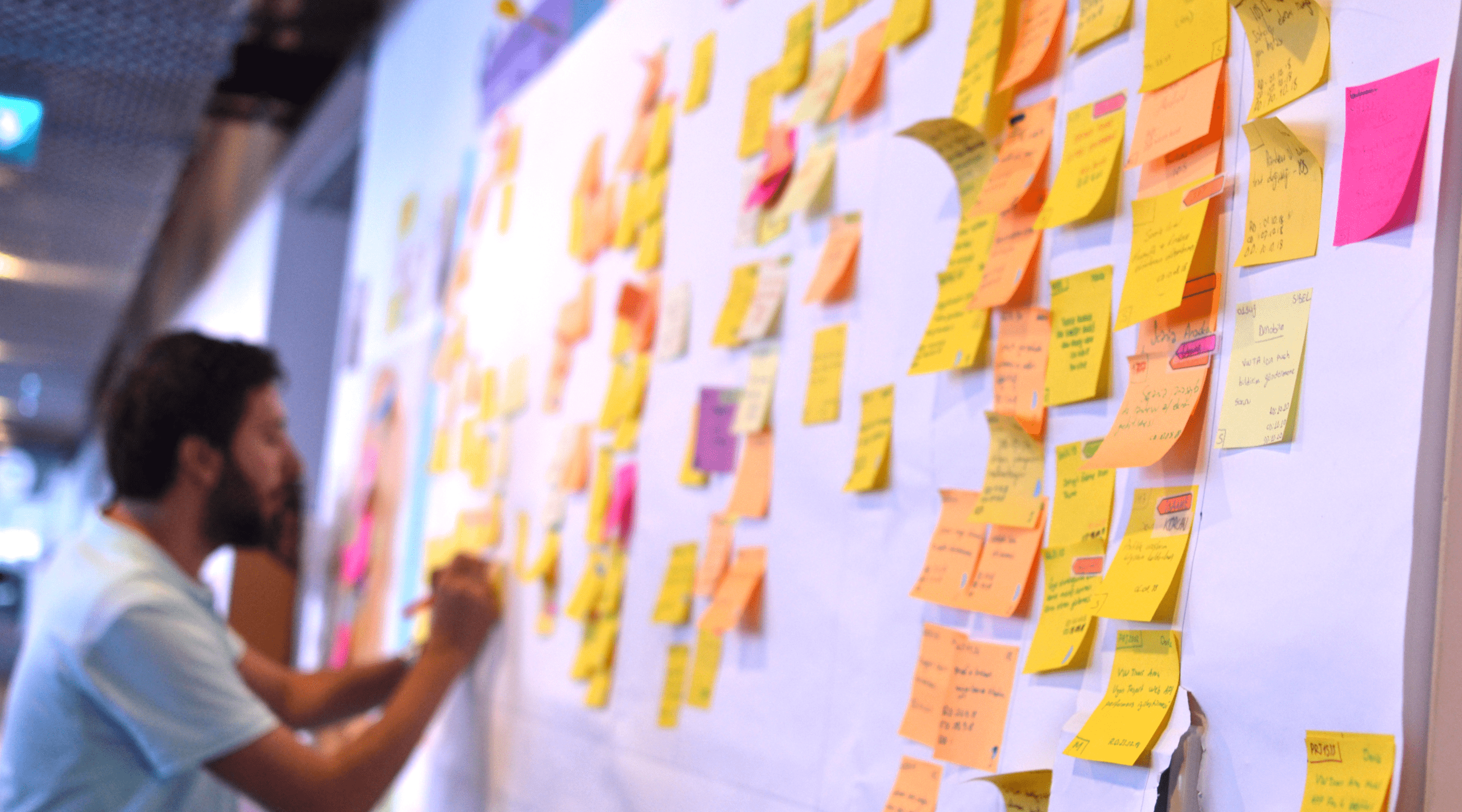 An IT worker tracking his tasks on Kanban board. Using Kanban board for task control is a kind of agile development methodology.