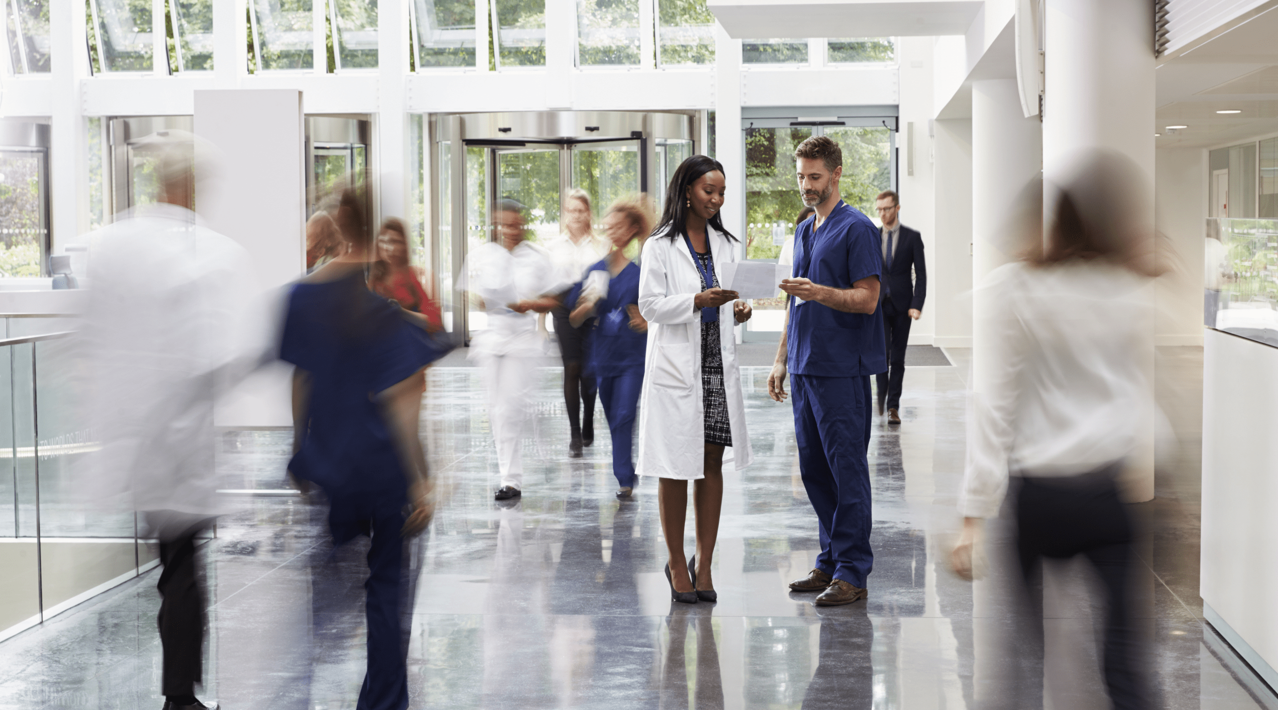 Personnel in the lobby of a busy hospital