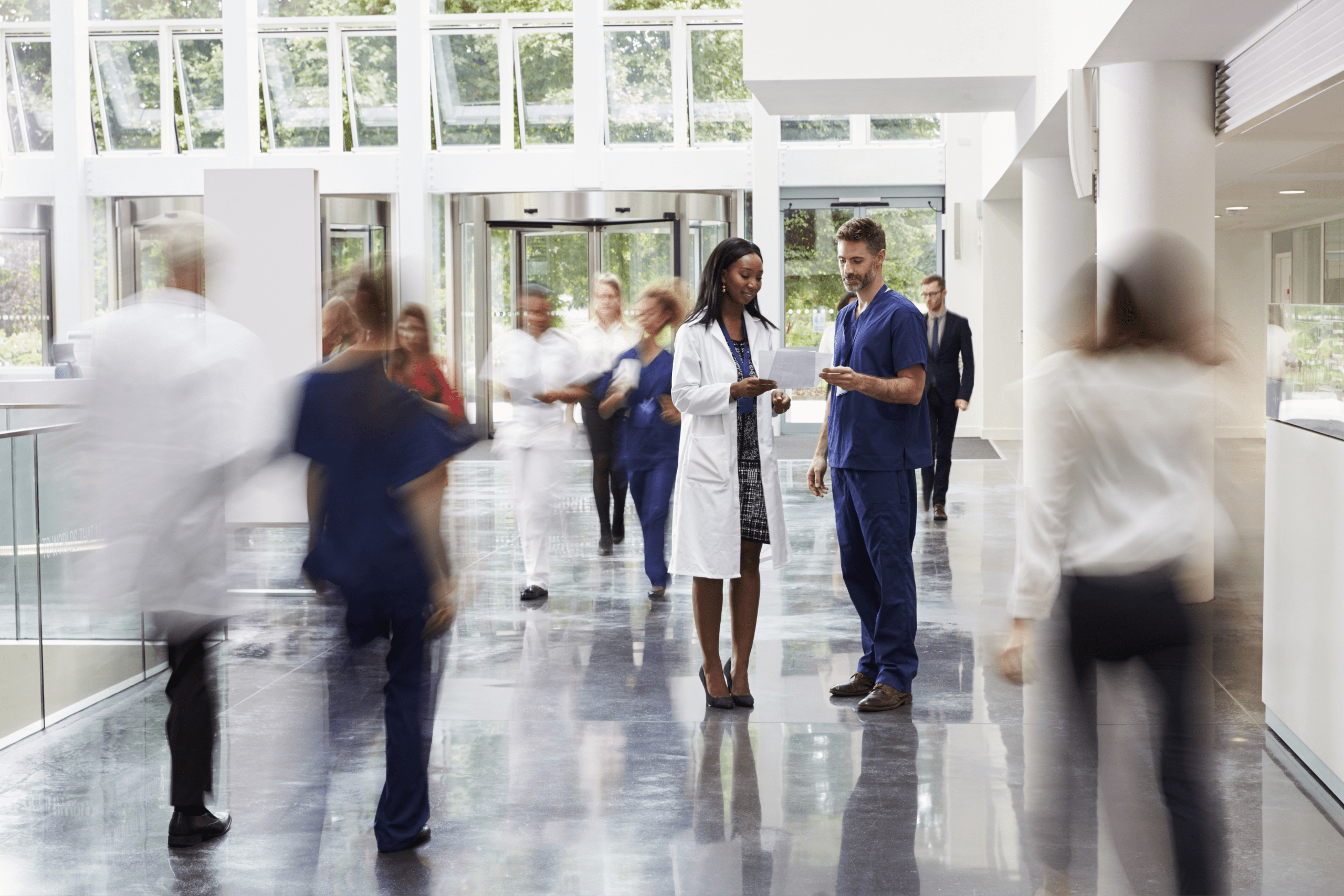 Personnel in the lobby of a busy hospital