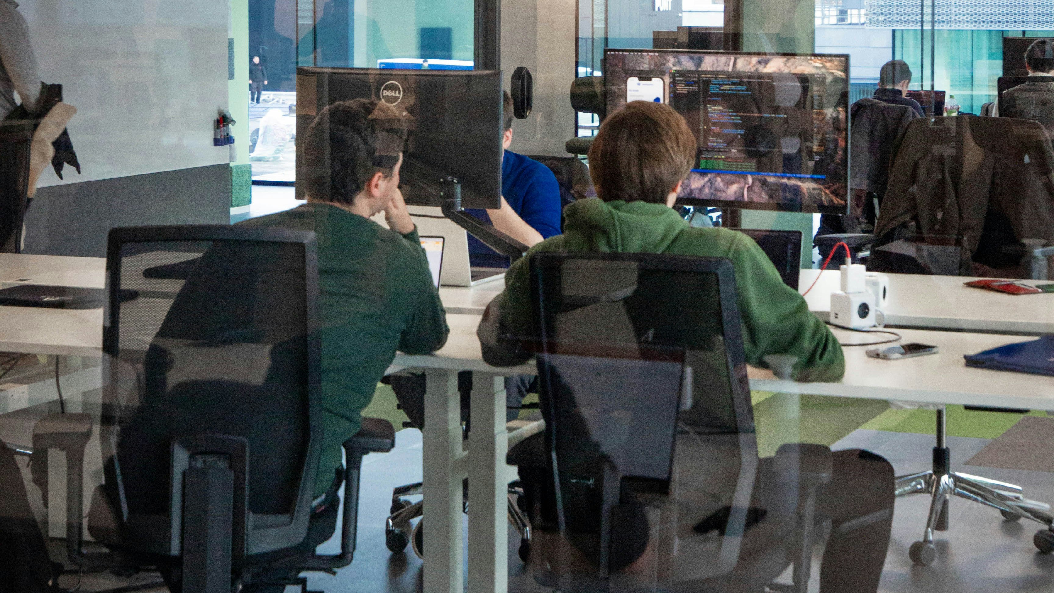 Two men working together on a computer